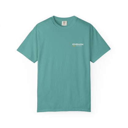 Teal t-shirt with a small white logo on a white background
