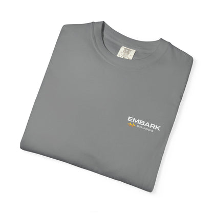 Folded gray t-shirt with a small logo on a white background