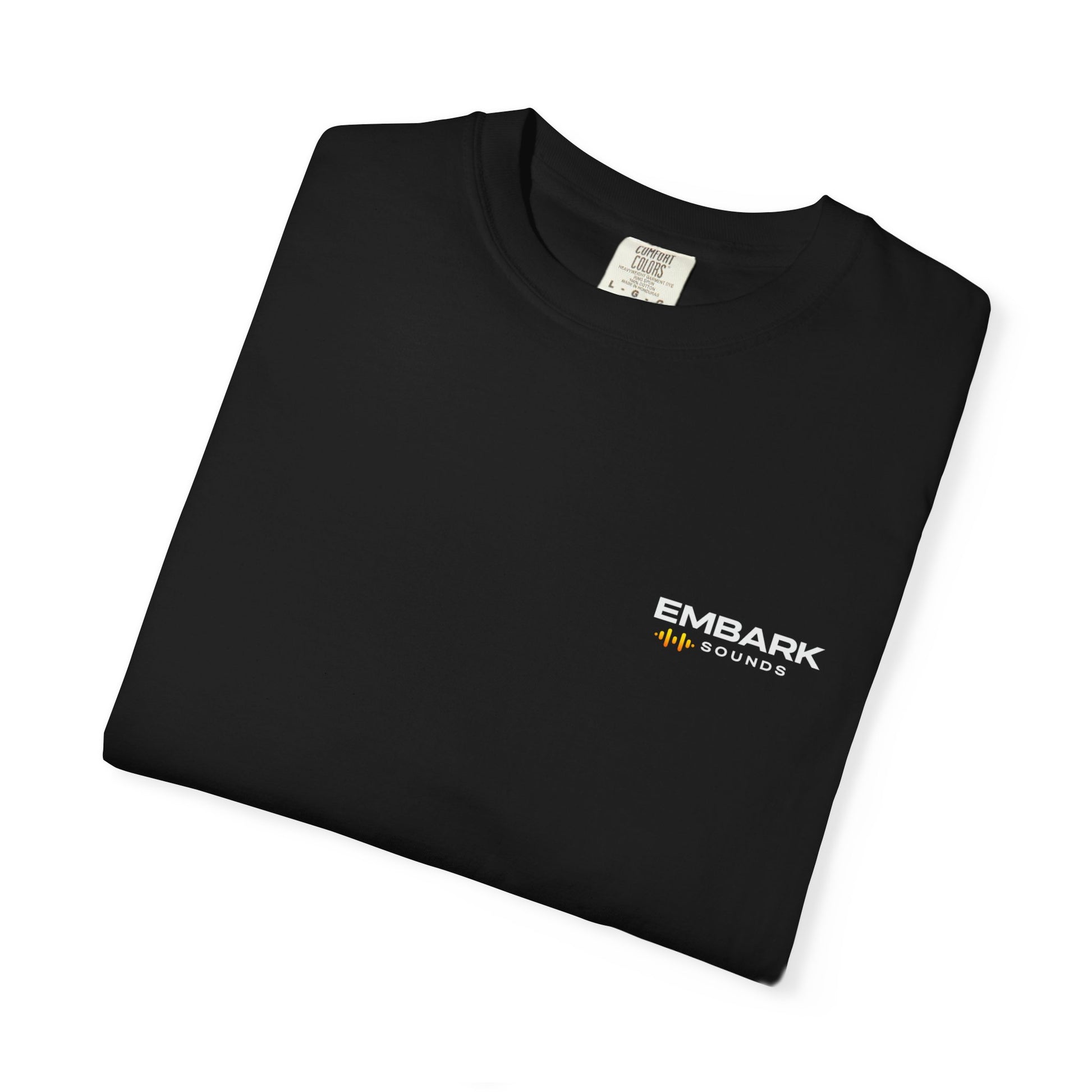 Folded navy blue t-shirt with Embark Sounds logo