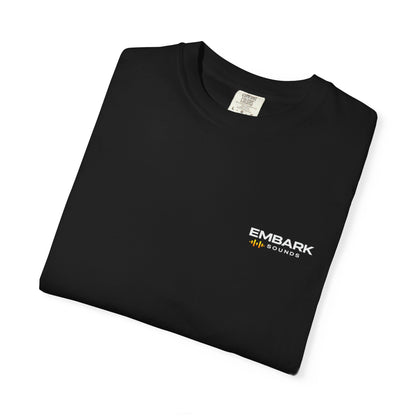 Folded navy blue t-shirt with Embark Sounds logo
