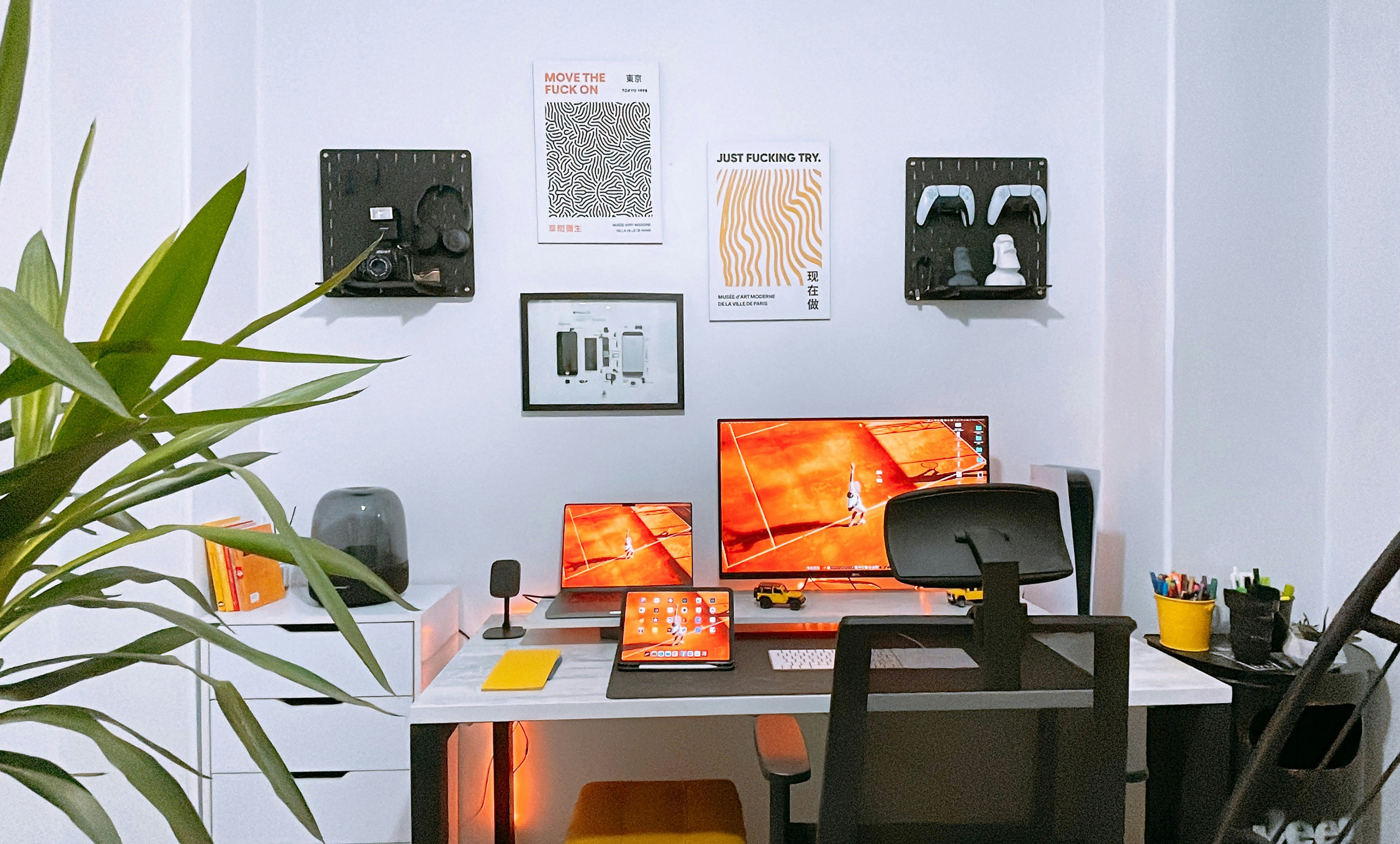 Modern home studio setup with Mac, monitors, and motivational posters — GarageBand users work in setups like this